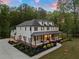 Beautiful two-story home featuring a covered porch, manicured landscaping and attached garages at 650 Jones Rd, Roswell, GA 30075