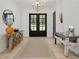 Elegant foyer with chandelier, black framed doors, and decorative furniture at 650 Jones Rd, Roswell, GA 30075