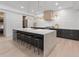 Open-concept kitchen with white marble countertops, custom cabinetry, and modern pendant lighting at 650 Jones Rd, Roswell, GA 30075