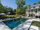 Stunning backyard with a modern in-ground pool, spa, lounge chairs, and outdoor dining area at 650 Jones Rd, Roswell, GA 30075