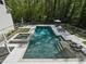 Aerial view of a backyard pool and attached hot tub featuring lounge chairs and umbrellas at 650 Jones Rd, Roswell, GA 30075