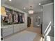 Spacious walk-in closet with custom shelving, drawers, wood floors, and a decorative light fixture at 650 Jones Rd, Roswell, GA 30075