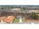 Aerial view of the home and surrounding wooded land with a graded area for future construction at 260 Harmony Woods Dr, Dallas, GA 30157