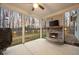 Outdoor back porch with stone fireplace, ceiling fan, and view of fenced-in backyard at 260 Harmony Woods Dr, Dallas, GA 30157