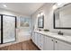Bathroom featuring double vanity, granite countertop, a large mirror, and shower with glass door at 260 Harmony Woods Dr, Dallas, GA 30157