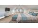 Spacious bedroom featuring a plush bed, flat screen TV, and sitting area with chairs and table at 260 Harmony Woods Dr, Dallas, GA 30157