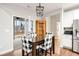 Dining area with stylish checkered chairs and natural light entering through French doors at 260 Harmony Woods Dr, Dallas, GA 30157