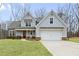 Charming two-story home with a well-manicured lawn and a two-car garage at 260 Harmony Woods Dr, Dallas, GA 30157