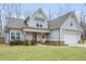 Attractive two-story home with an attached garage, lush lawn, and traditional craftsman appeal at 260 Harmony Woods Dr, Dallas, GA 30157