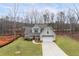 Front exterior view of the home highlighting the well-maintained lawn and classic architecture at 260 Harmony Woods Dr, Dallas, GA 30157