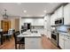 Bright kitchen featuring white cabinets, stainless steel appliances, and a granite island at 260 Harmony Woods Dr, Dallas, GA 30157