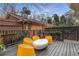 Rear outdoor patio seating area with modern yellow chairs, perfect for relaxing and enjoying time outside at 2861 Dorby Close Ne, Brookhaven, GA 30319