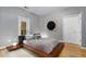 Stylish bedroom with a modern platform bed, light hardwood floors, and access to the balcony at 2861 Dorby Close Ne, Brookhaven, GA 30319