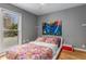 A cozy bedroom with colorful bedding, hardwood floors and a large window at 2861 Dorby Close Ne, Brookhaven, GA 30319
