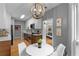 Dining area with stainless steel appliances, modern chandelier, and artwork at 2861 Dorby Close Ne, Brookhaven, GA 30319