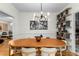 Dining room featuring a unique chandelier, a dining table with modern chairs, and open shelving at 2861 Dorby Close Ne, Brookhaven, GA 30319