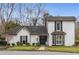 Charming two-story home with a well-manicured lawn, white brick facade, and black door at 2861 Dorby Close Ne, Brookhaven, GA 30319