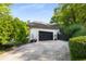 A long, wide driveway leading to a two car garage, enclosed by lush, green landscaping at 2861 Dorby Close Ne, Brookhaven, GA 30319