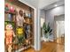 Hallway featuring custom shelving with decorative items and an entrance to another room with a large mirror at 2861 Dorby Close Ne, Brookhaven, GA 30319