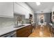 Modern kitchen with stainless steel appliances, tile backsplash, and wood flooring at 2861 Dorby Close Ne, Brookhaven, GA 30319