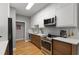 Well lit kitchen with stainless steel appliances, wooden floors, and white cabinets at 2861 Dorby Close Ne, Brookhaven, GA 30319