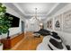 Open-concept living room with modern lighting, hardwood floors, and stylish furnishings at 2861 Dorby Close Ne, Brookhaven, GA 30319
