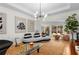 Stylish living room with a modern chandelier, unique decor, and access to the outdoor area at 2861 Dorby Close Ne, Brookhaven, GA 30319