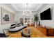 Elegant living room with a modern chandelier, contemporary decor, and a large screen television at 2861 Dorby Close Ne, Brookhaven, GA 30319