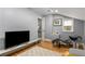 Brightly lit sitting area with a comfortable lounge chair and hardwood floors at 2861 Dorby Close Ne, Brookhaven, GA 30319