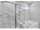Luxurious bathroom featuring a marble-tiled shower, a soaking tub, and modern fixtures at 404 Village Ln, Fairburn, GA 30213
