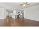 Open-concept living area with hardwood floors, kitchen island, and ample space for entertaining at 404 Village Ln, Fairburn, GA 30213