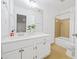 Bright bathroom featuring a white vanity, large mirror, and a combined shower and tub with ceramic tile surround at 1659 Executive Park Ne Ln, Brookhaven, GA 30329