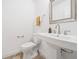 Traditional powder room featuring a pedestal sink, brushed nickel faucet, and a square framed mirror at 1659 Executive Park Ne Ln, Brookhaven, GA 30329