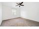 Bright bedroom with carpet, a ceiling fan, and a window providing natural light at 1659 Executive Park Ne Ln, Brookhaven, GA 30329