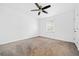 Spacious bedroom with neutral carpet, a ceiling fan, and a window providing natural light at 1659 Executive Park Ne Ln, Brookhaven, GA 30329