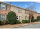 Charming brick townhome with manicured bushes, shutters, and inviting entrance at 1659 Executive Park Ne Ln, Brookhaven, GA 30329