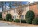 Charming brick townhome featuring manicured landscaping and a welcoming entrance at 1659 Executive Park Ne Ln, Brookhaven, GA 30329