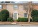 Lovely brick townhome with tidy landscaping, front entrance and symmetrical façade at 1659 Executive Park Ne Ln, Brookhaven, GA 30329