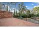 Outdoor patio area with brick floor and metal railing overlooking trees and greenery at 1659 Executive Park Ne Ln, Brookhaven, GA 30329