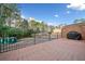 View of the backyard from the patio, featuring brick flooring and black metal railing at 1659 Executive Park Ne Ln, Brookhaven, GA 30329