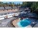 Aerial view of a community in-ground pool surrounded by brick townhomes at 1659 Executive Park Ne Ln, Brookhaven, GA 30329