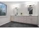 Bright bathroom featuring double vanity with modern lighting, and a window overlooking the outdoors at 190 Adair Se Ave, Atlanta, GA 30315