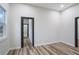 Bright bedroom with wood-look floors, recessed lighting, and a view into the bathroom at 190 Adair Se Ave, Atlanta, GA 30315