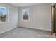 Bedroom with soft carpet, neutral walls, two windows, and access to an attached bathroom at 190 Adair Se Ave, Atlanta, GA 30315