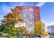 The Landmark Condominiums is a high-rise with a sign, trees, and a few cars parked in front of the building at 215 Piedmont Ne Ave # 204, Atlanta, GA 30308