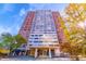 Stunning high-rise brick building with a prominent entrance and vibrant autumn foliage at 215 Piedmont Ne Ave # 204, Atlanta, GA 30308