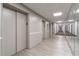 Hallway with wood flooring, elevator access, and mirrored walls provides a clean, modern, and efficient access point at 215 Piedmont Ne Ave # 204, Atlanta, GA 30308