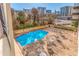 View of pool with lounge chairs and tables provides a relaxing outdoor experience with a cityscape backdrop at 215 Piedmont Ne Ave # 204, Atlanta, GA 30308