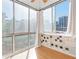 Inviting sunroom with large windows offering views of the city skyline at 215 Piedmont Ne Ave # 204, Atlanta, GA 30308