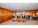 This is an unfinished basement area with bar, bar stools, wood paneled walls and tiled ceiling at 2798 Tralyn Ct, Decatur, GA 30034